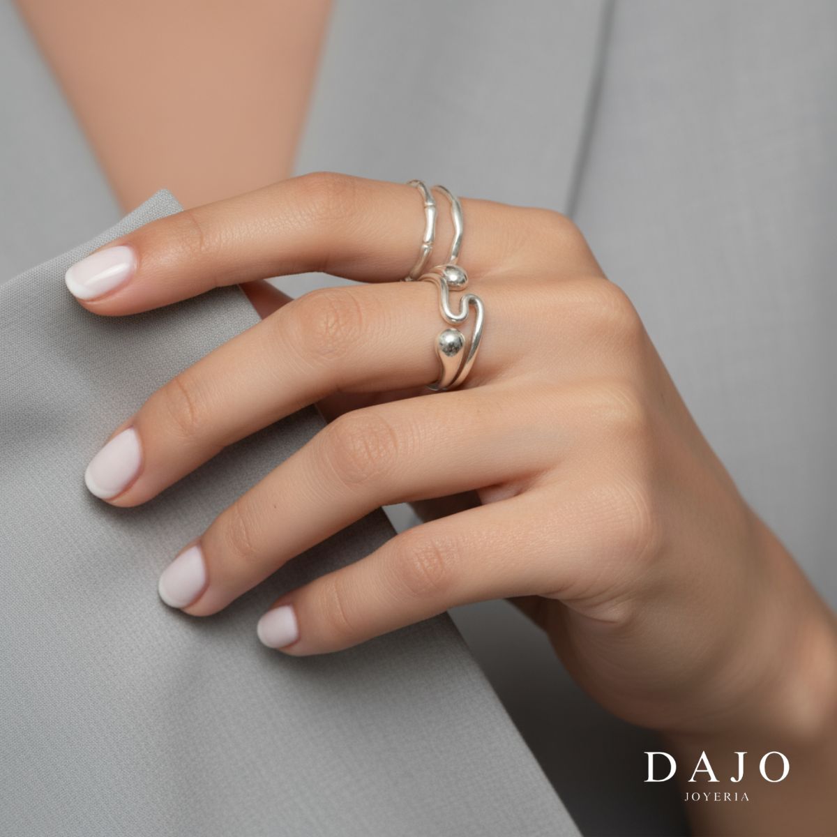 Modelo mujer usando combinación set de joyería anillos plata .925 estilo elegante. Mostrando manos y antebrazo